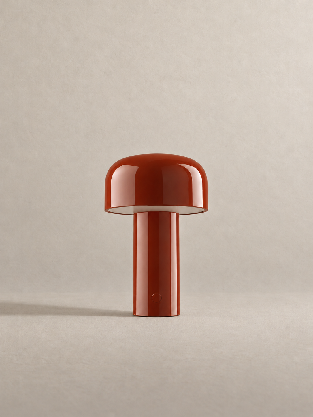 Portable dome lamp in Brick Red, light off, warm neutral studio
