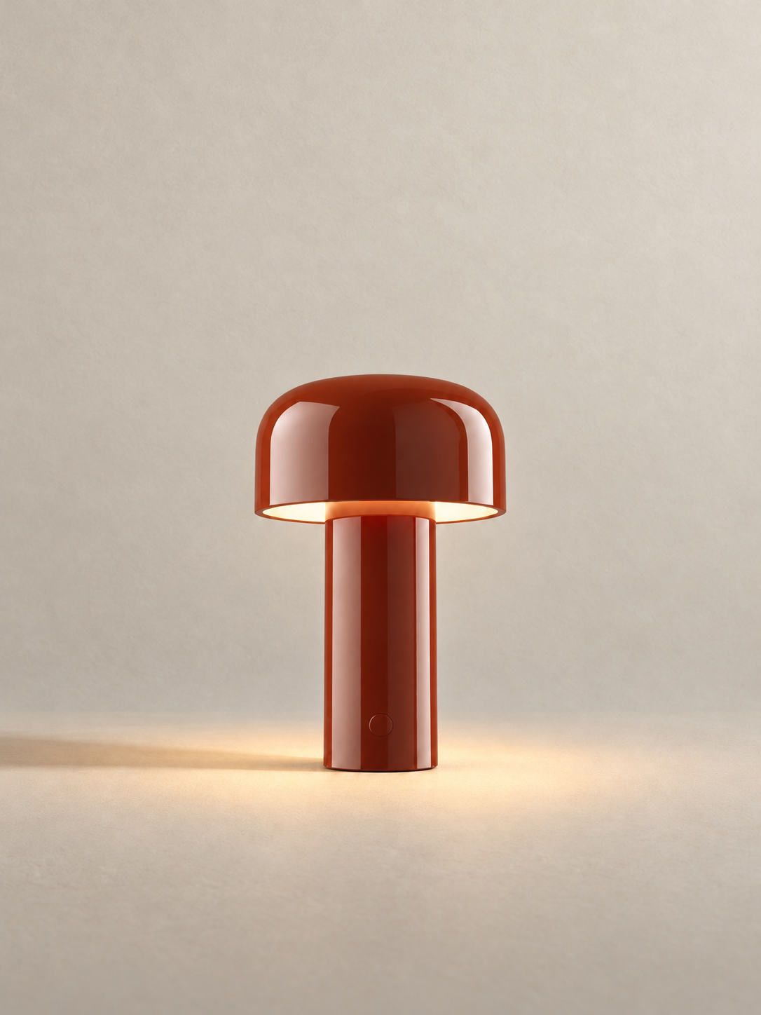 Portable dome lamp in Brick Red, light on, warm neutral studio