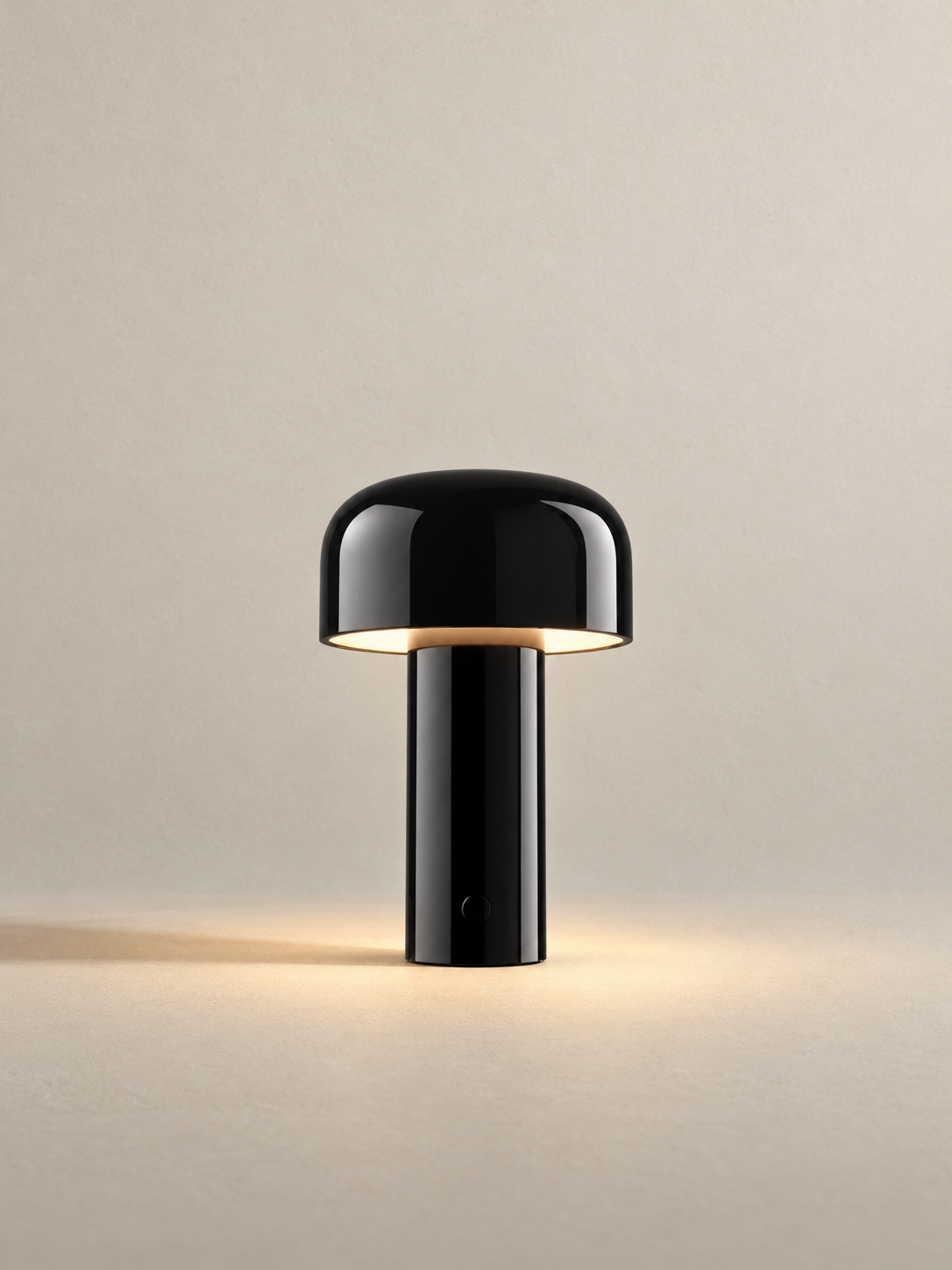 Portable dome lamp in Glossy Black, light on, warm neutral studio