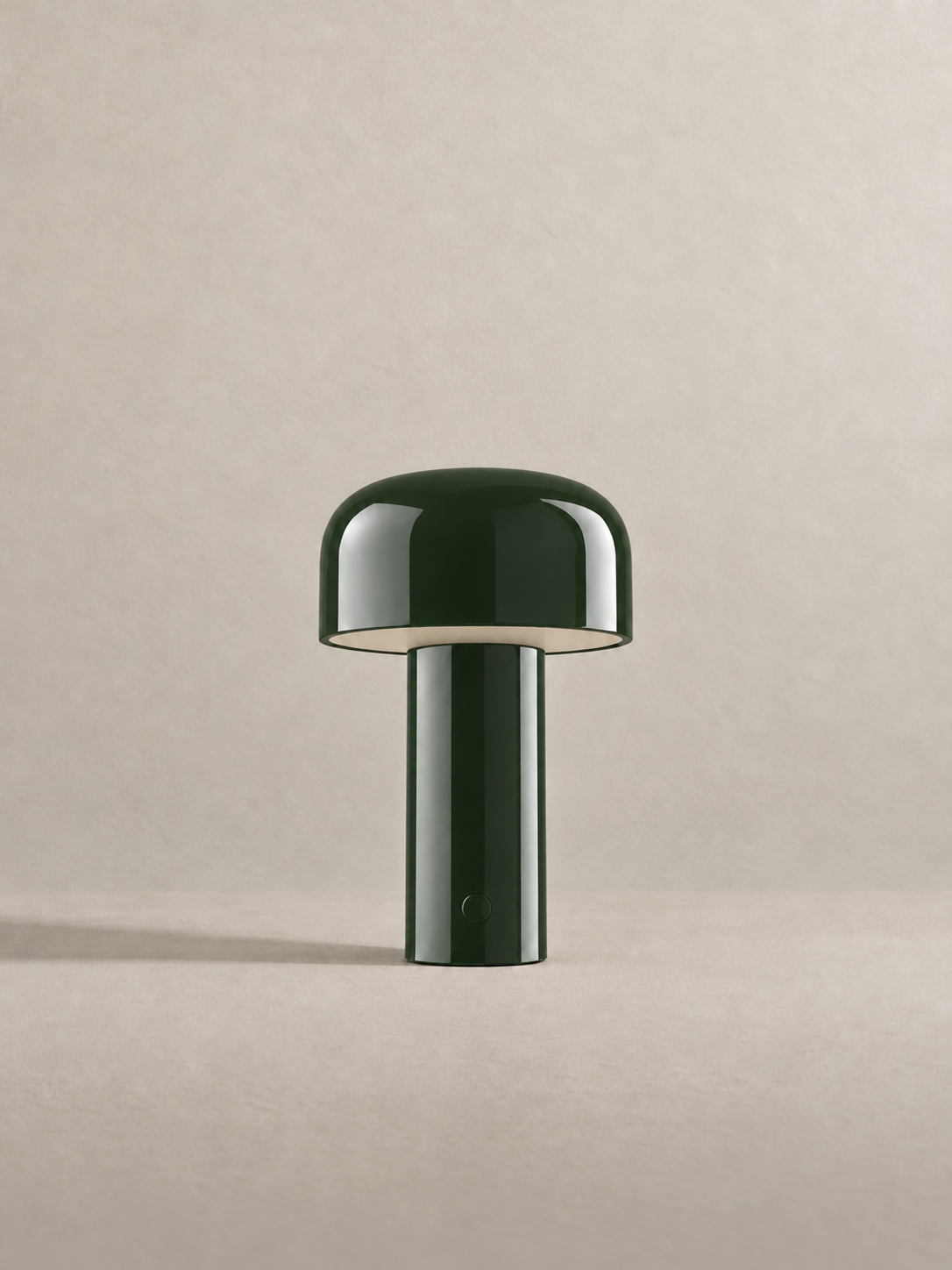 Portable dome lamp in Glossy Green, light off, warm neutral studio