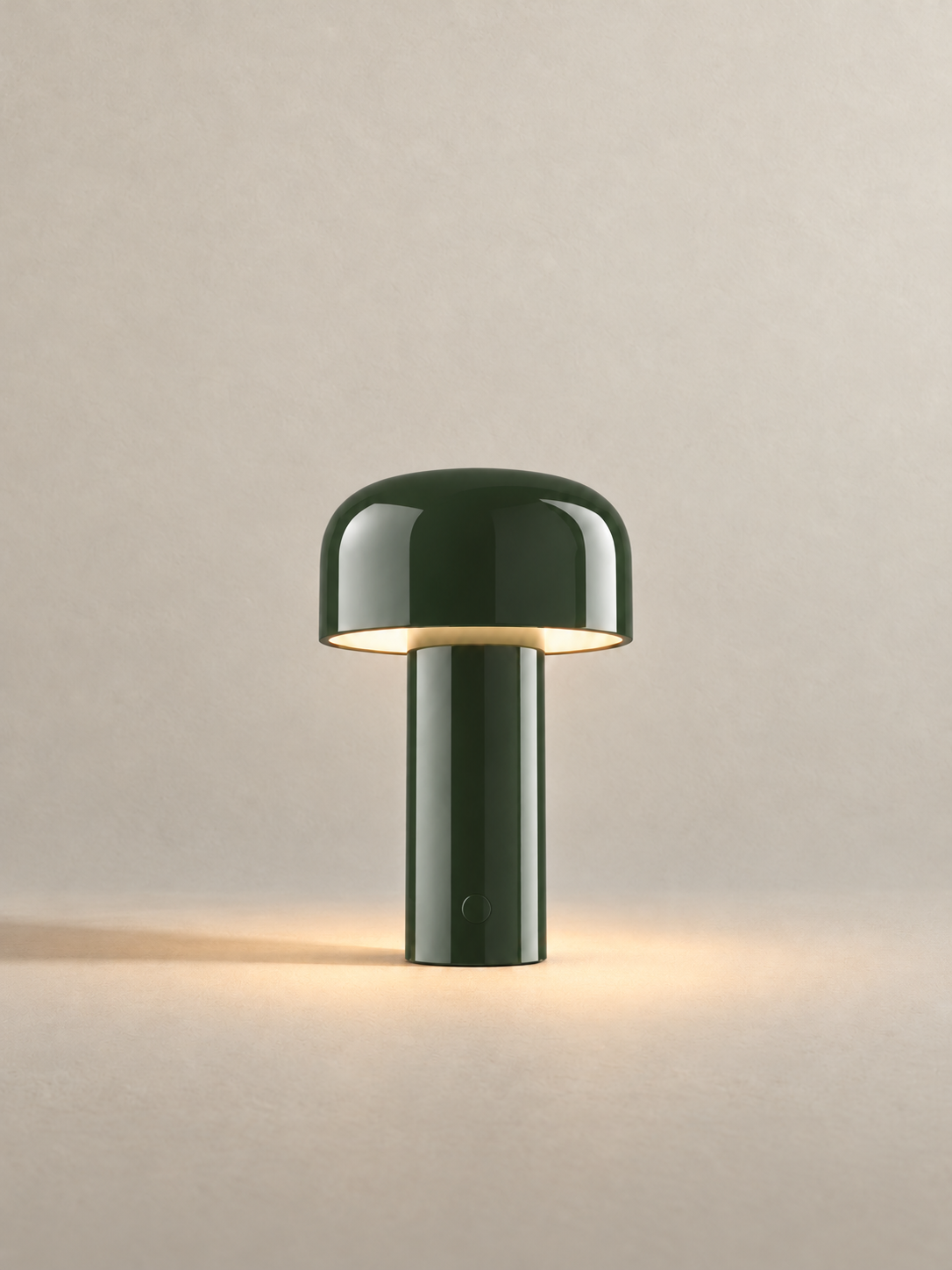 Portable dome lamp in Glossy Green, light on, warm neutral studio