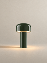 Portable dome lamp in Glossy Green, light on, warm neutral studio